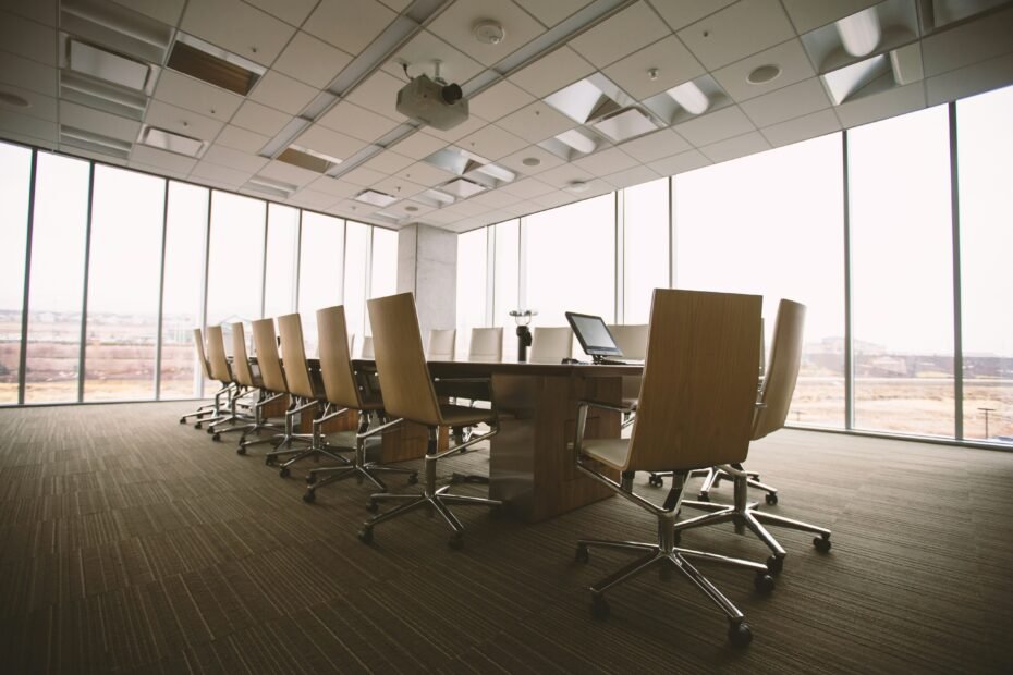 Large empty conference room with a huge table and chairs